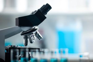 professional microscope in laboratory, science equipment and medical tools to looking micro scale, microbiology and medicine research in laboratory with microscope